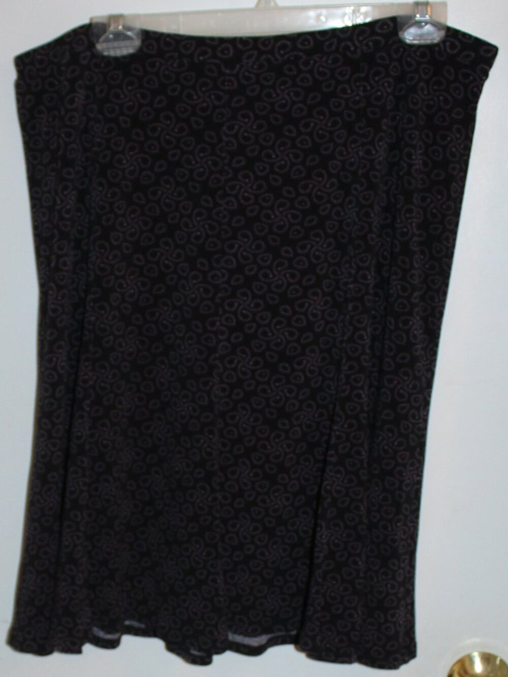 Black knee-length skirt with  abstract circular pattern in purple